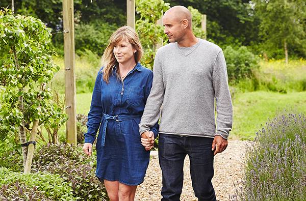 Picture of Anabel & Barnabas Kindersley walking through the pear orchard at the Peacemarsh Eco-Factory